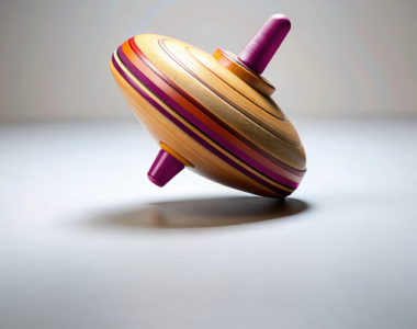 Image of a colourful spinning top tilting off balance, symbolizing market volatility and wobbly financial conditions