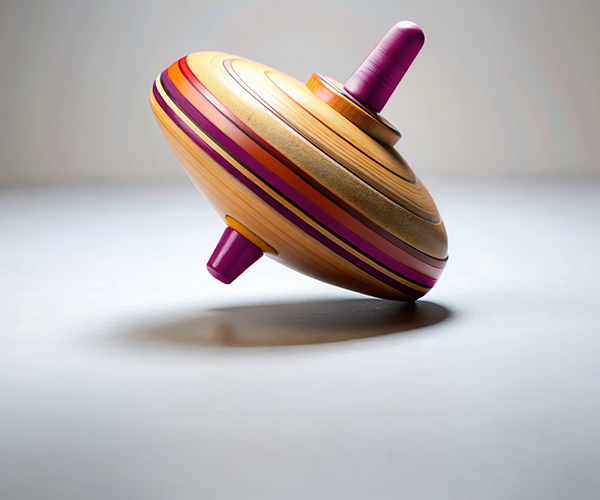 Image of a colourful spinning top tilting off balance, symbolizing market volatility and wobbly financial conditions