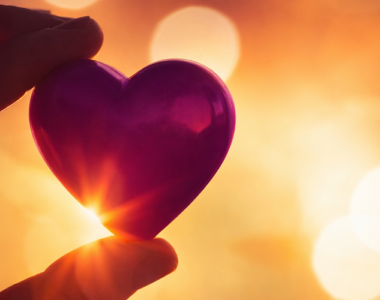 holding a heart shaped glass