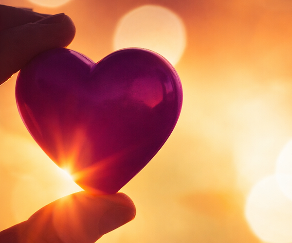 holding a heart shaped glass
