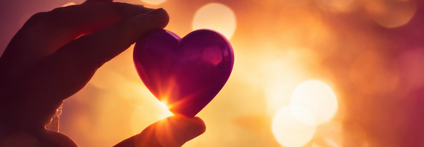 holding a heart shaped glass